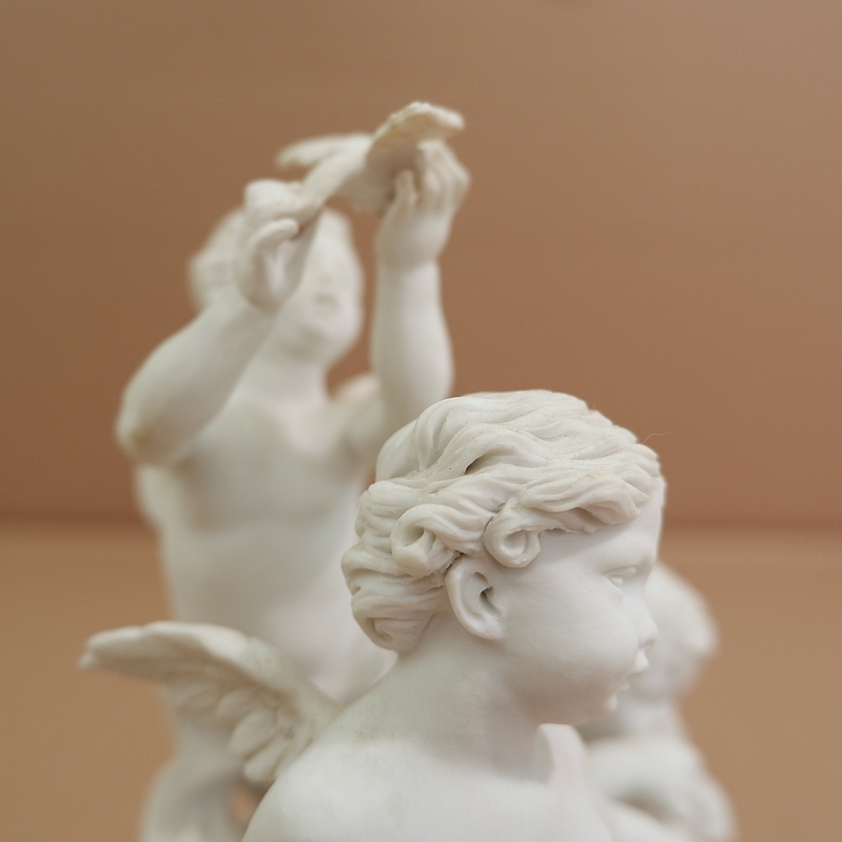 Three cherubs  in white porcelain biscuit 19th