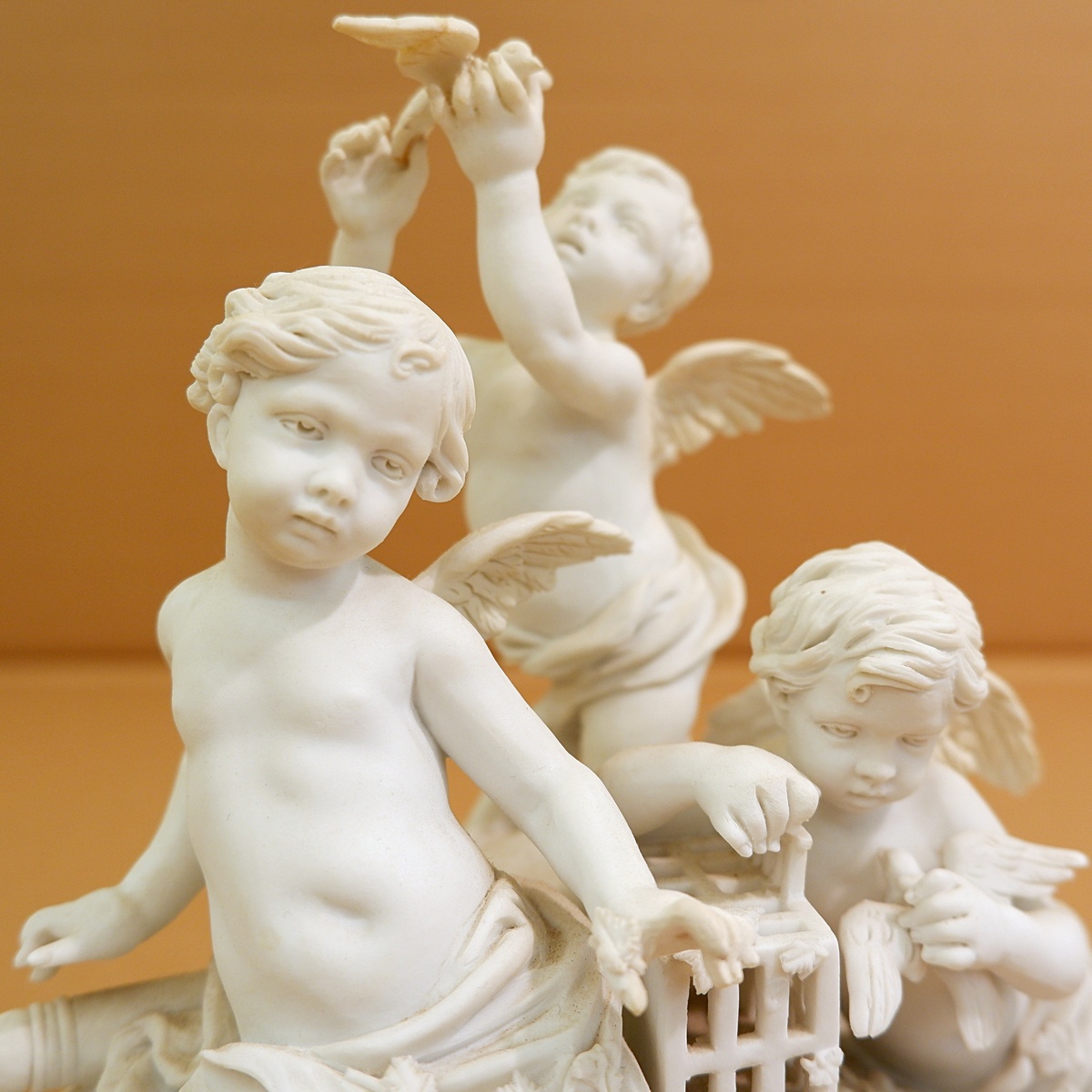 Three cherubs  in white porcelain biscuit 19th
